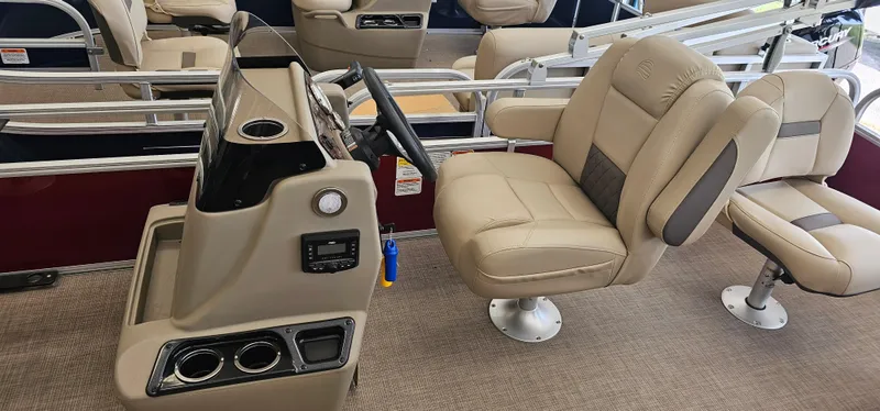 Slide: The Image of 2025 Sun Tracker Bass Buggy 18 DLX interior with beige captain's chair and steering console. - 7