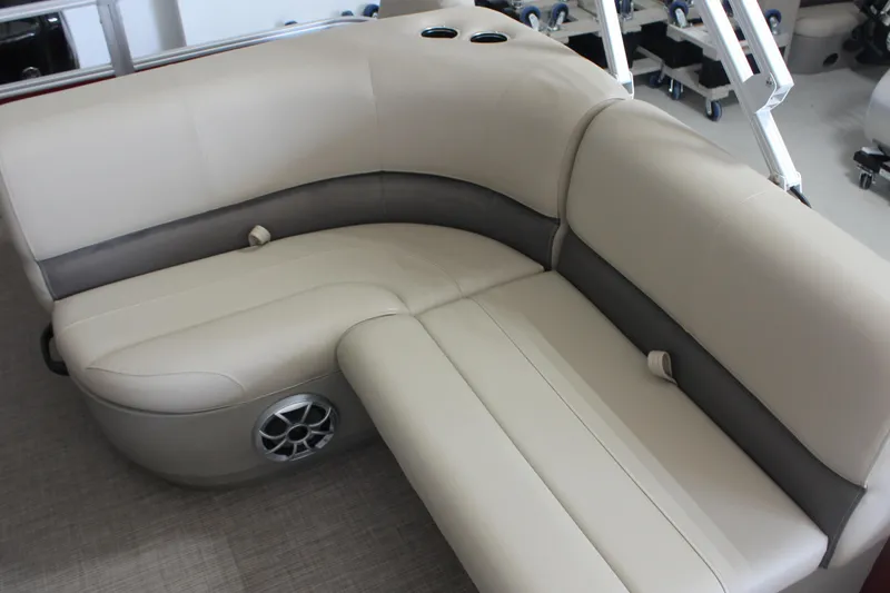 Slide: The Image of 2025 Sun Tracker Party Barge 18 DLX interior seating with cup holders and speaker. - 10