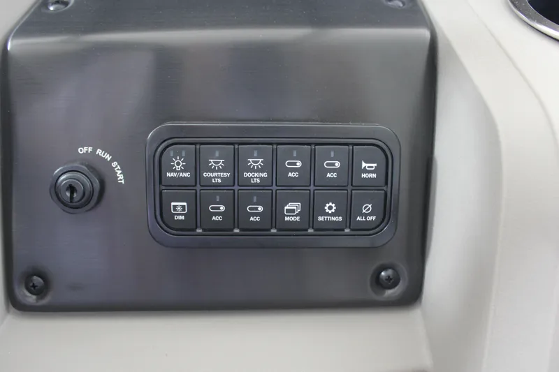 Slide: The Image of Control panel of 2025 Sun Tracker Party Barge 18 DLX with various switches and ignition. - 7
