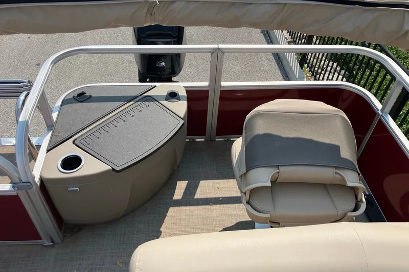 Slide: The Image of 2025 Sun Tracker Bass Buggy 18 DLX pontoon boat interior with seating and console. - 10