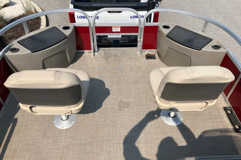 Slide: The Image of 2025 Sun Tracker Bass Buggy 18 DLX interior with beige seats and fishing stations. - 11