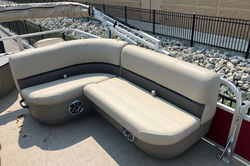 Slide: The Image of 2025 Sun Tracker Bass Buggy 18 DLX pontoon boat with beige seating and speaker system. - 7