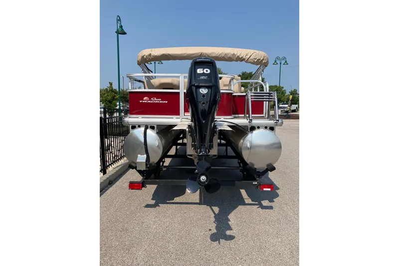 Slide: The Image of 2025 Sun Tracker Bass Buggy 18 DLX pontoon boat with 60 HP engine, rear view. - 4