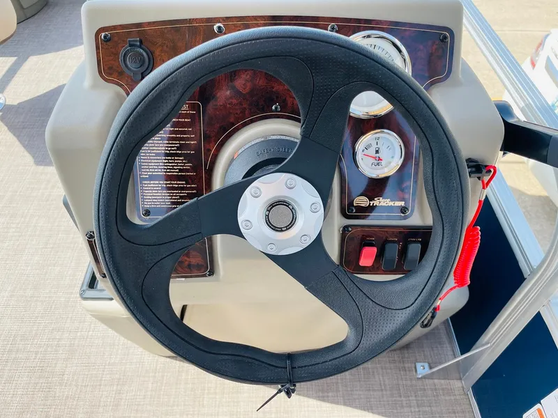 Slide: The Image of Steering wheel and dashboard of 2025 Sun Tracker Bass Buggy 18 DLX pontoon boat. - 19