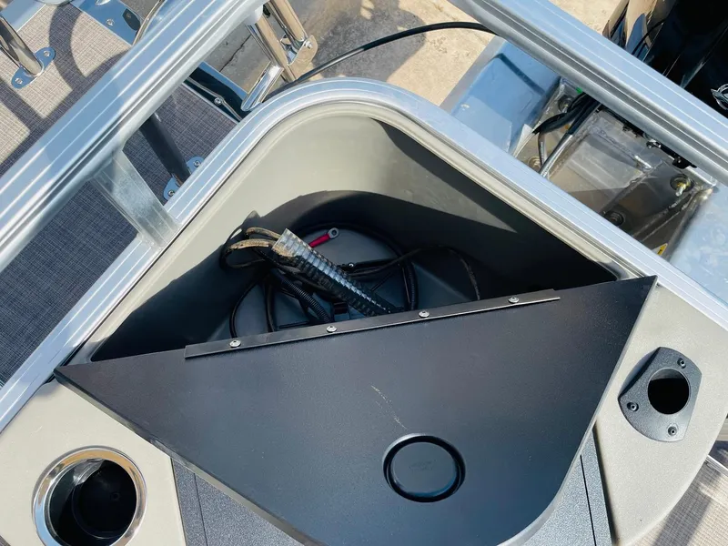 Slide: The Image of 2025 Sun Tracker Bass Buggy 18 DLX storage compartment with cup holder and wiring. - 28