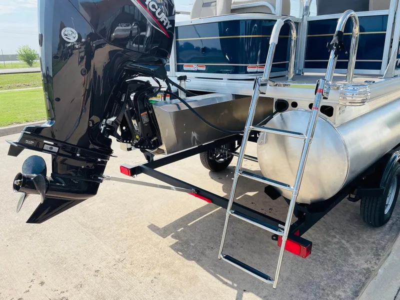 Slide: The Image of 2025 Sun Tracker Bass Buggy 18 DLX pontoon boat with outboard motor and ladder. - 6