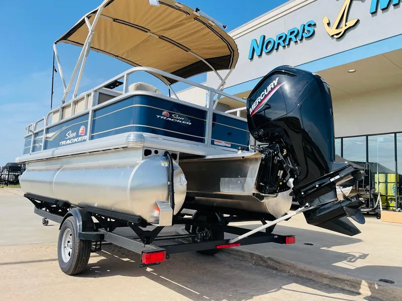 Slide: The Image of 2025 Sun Tracker Bass Buggy 18 DLX pontoon boat with Mercury engine at dealership. - 7