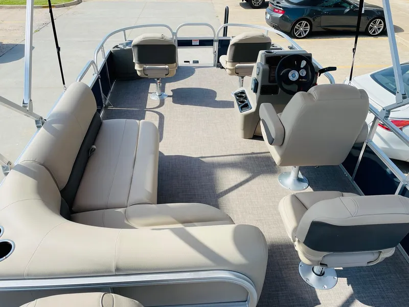 Slide: The Image of 2025 Sun Tracker Bass Buggy 18 DLX pontoon boat interior with beige seating. - 8