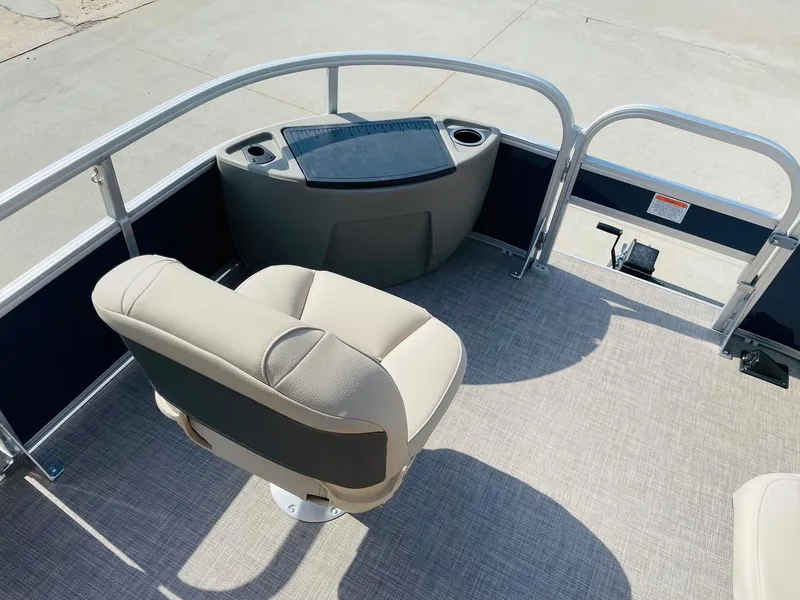 Slide: The Image of 2025 Sun Tracker Bass Buggy 18 DLX pontoon boat interior with captain's chair and console. - 9