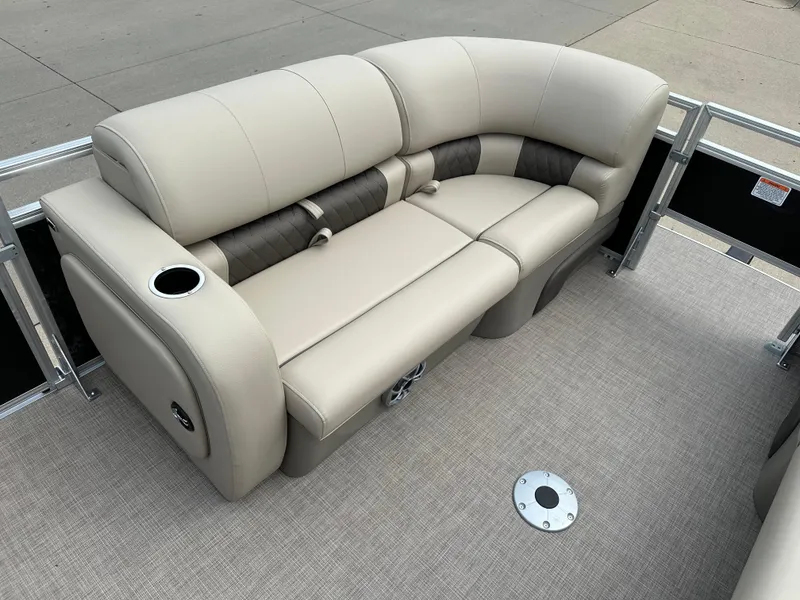 Slide: The Image of 2025 Sun Tracker SportFish 22 DLX pontoon boat with beige seating and cup holder. - 3