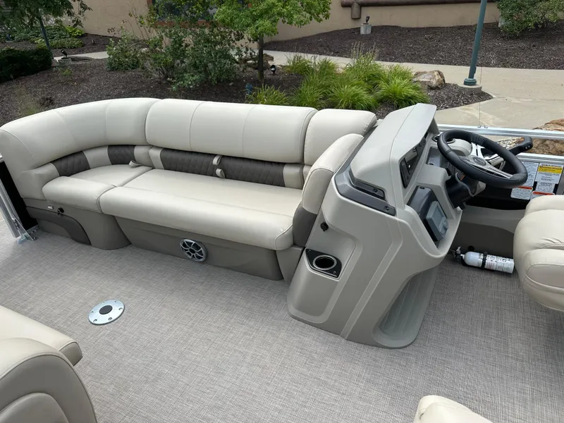 Slide: The Image of 2025 Sun Tracker SportFish 22 DLX interior with beige seating and modern helm. - 4