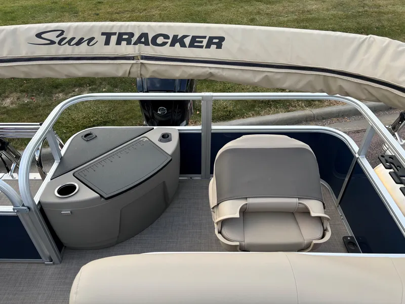 Slide: The Image of 2025 Sun Tracker Bass Buggy 18 DLX pontoon boat interior with seating and console. - 10