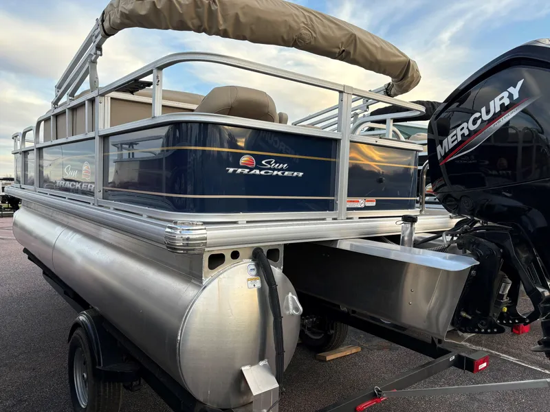 Slide: The Image of 2025 Sun Tracker Bass Buggy 18 DLX pontoon boat with Mercury outboard motor. - 3