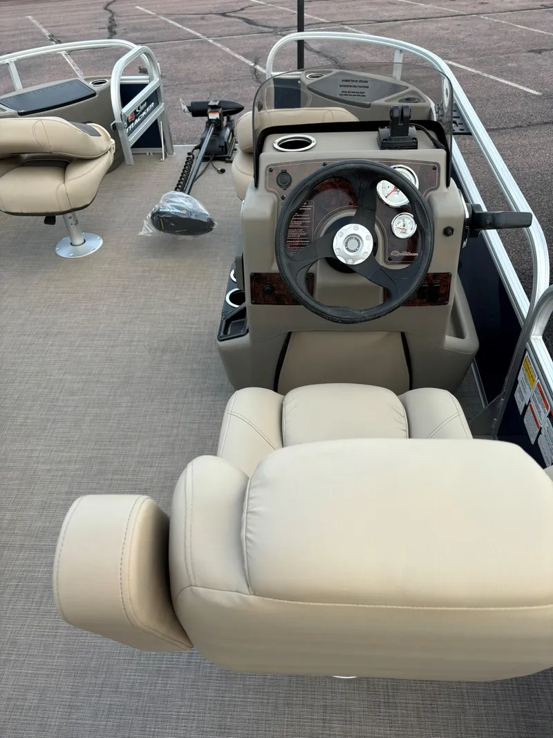 Slide: The Image of 2025 Sun Tracker Bass Buggy 18 DLX pontoon boat interior with steering console and seating. - 6