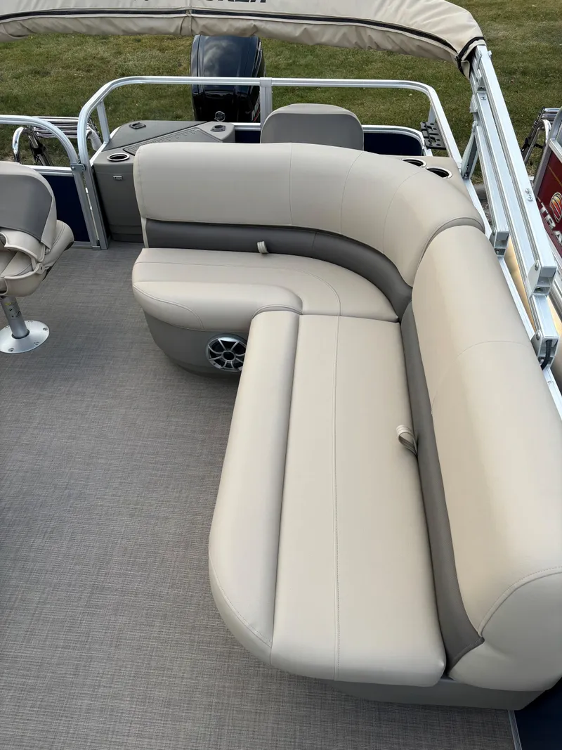 Slide: The Image of 2025 Sun Tracker Bass Buggy 18 DLX pontoon boat with beige seating and spacious deck. - 9