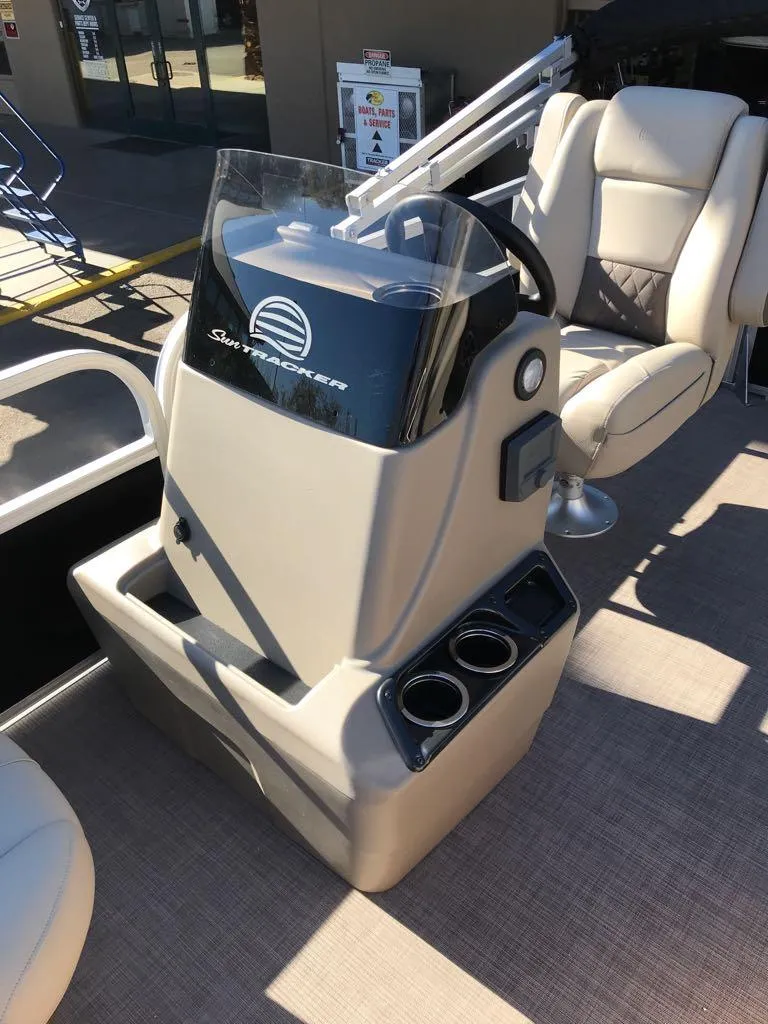 Slide: The Image of 2025 Sun Tracker Party Barge 16 DLX helm with comfortable seating and modern controls. - 13