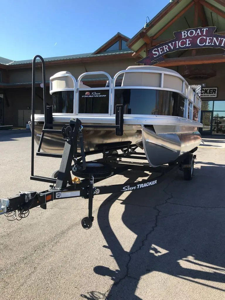 Slide: The Image of 2025 Sun Tracker Party Barge 16 DLX pontoon boat at service center. - 2