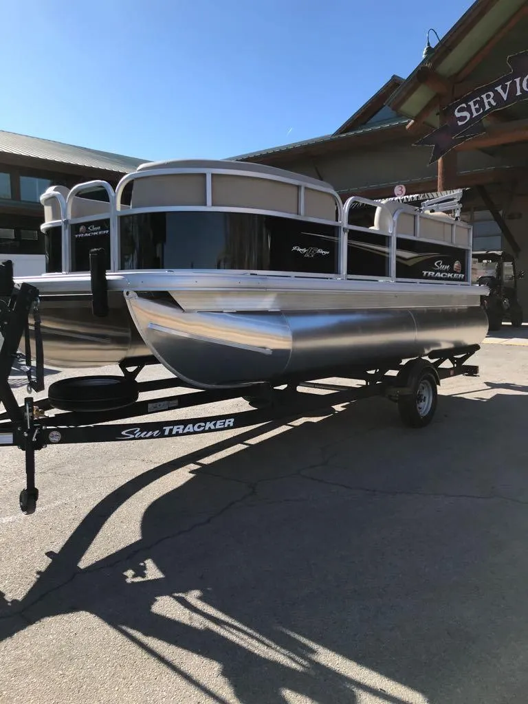 Slide: The Image of 2025 Sun Tracker Party Barge 16 DLX pontoon boat on trailer. - 3