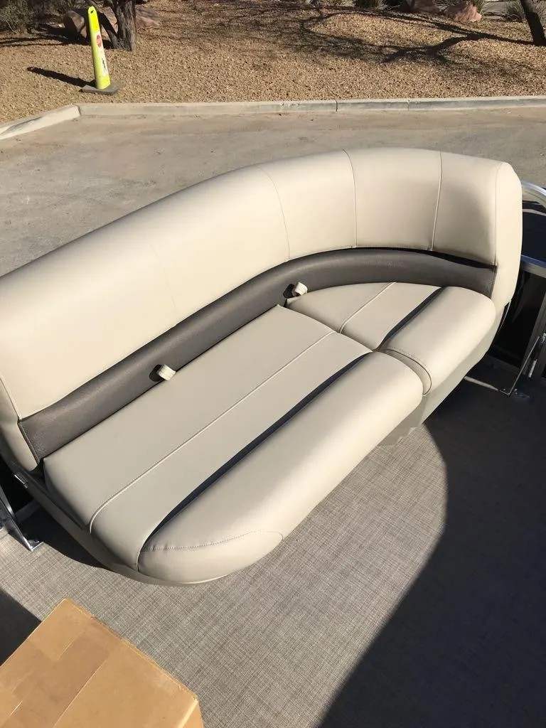 Slide: The Image of 2025 Sun Tracker Party Barge 16 DLX beige seating on deck. - 8