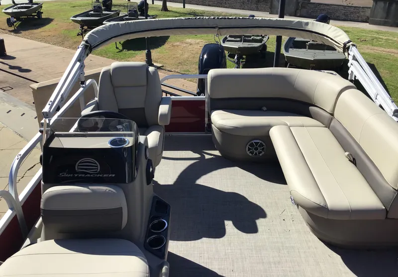 Slide: The Image of 2025 Sun Tracker Bass Buggy 16 XL Select pontoon boat with spacious seating and modern design. - 2