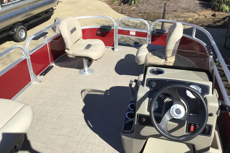 Slide: The Image of 2025 Sun Tracker Bass Buggy 16 XL Select pontoon boat interior with steering console and seating. - 3