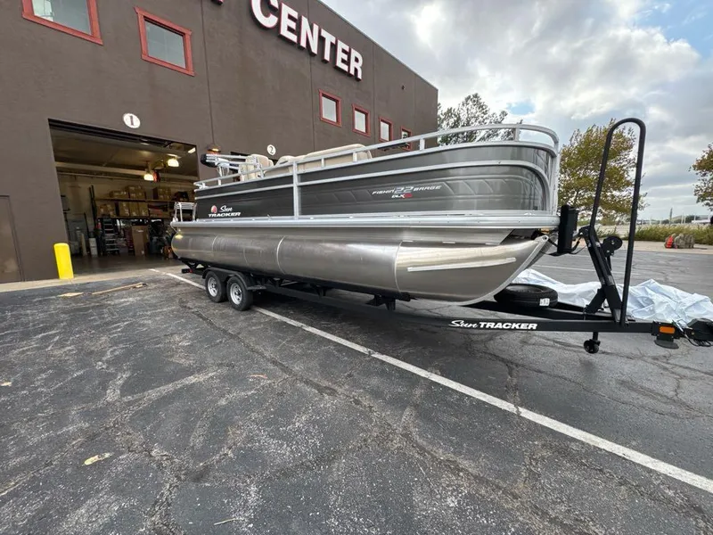 Slide: The Image of 2025 Sun Tracker Fishin' Barge 22 XP3 pontoon boat outside service center. - 6
