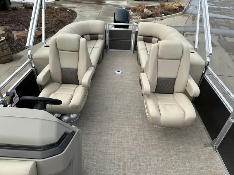 Slide: The Image of 2025 Sun Tracker Party Barge 24 DLX with beige seating and spacious deck layout. - 7