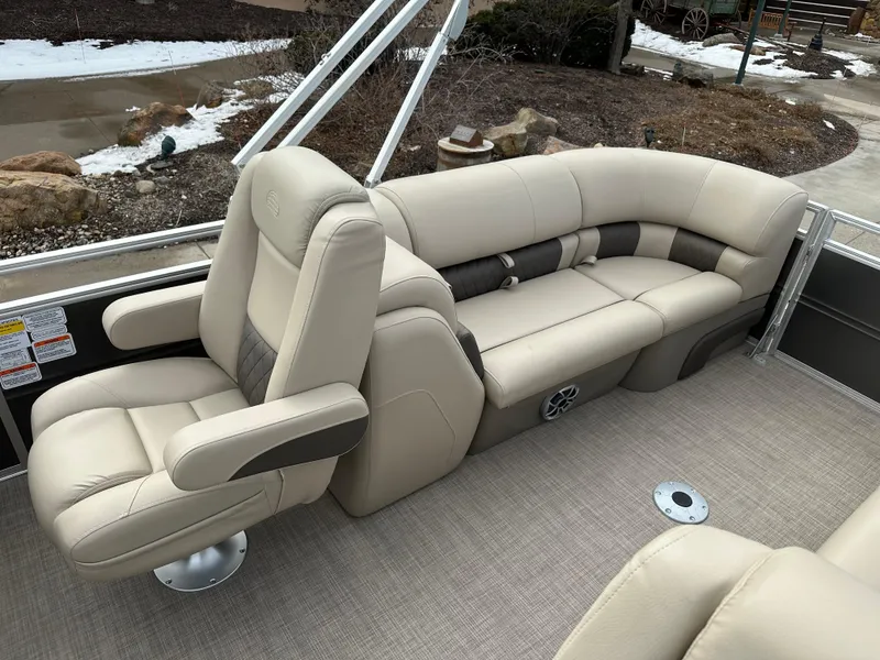 Slide: The Image of 2025 Sun Tracker Party Barge 24 DLX interior with beige seating and carpeted floor. - 8