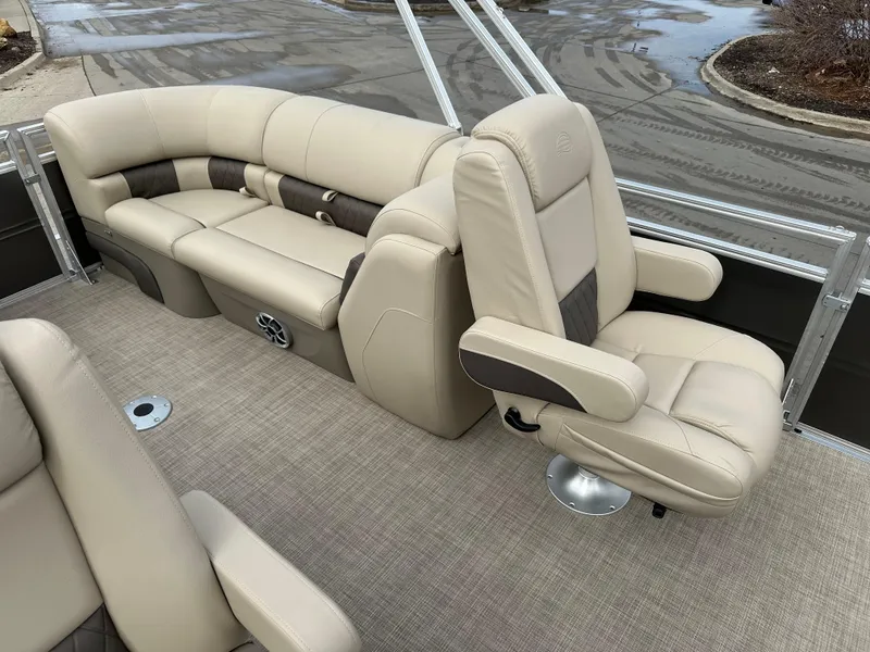 Slide: The Image of 2025 Sun Tracker Party Barge 24 DLX interior with beige seating and carpeted flooring. - 9