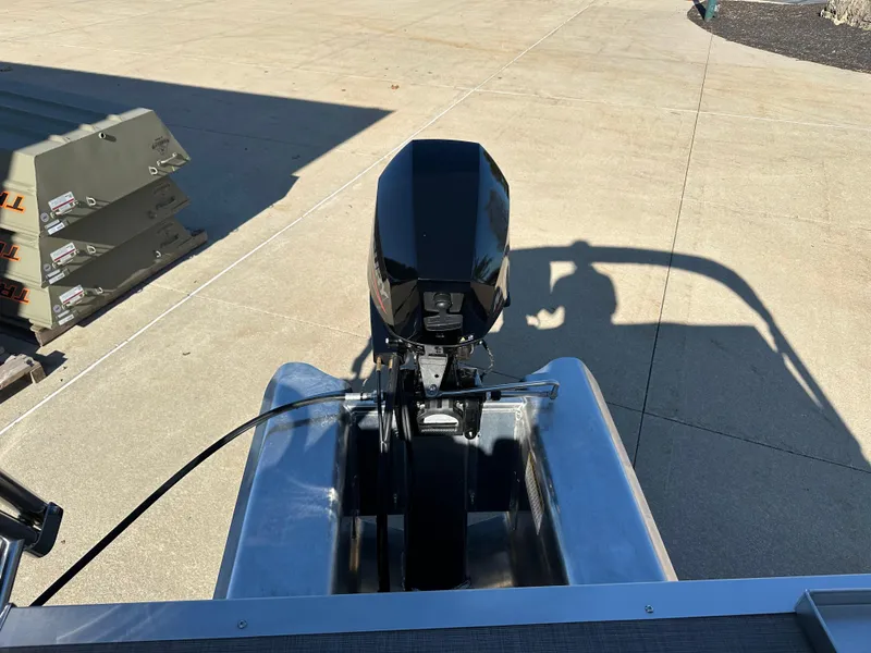 Slide: The Image of 2025 Sun Tracker Party Barge 16 DLX outboard motor on concrete surface. - 4