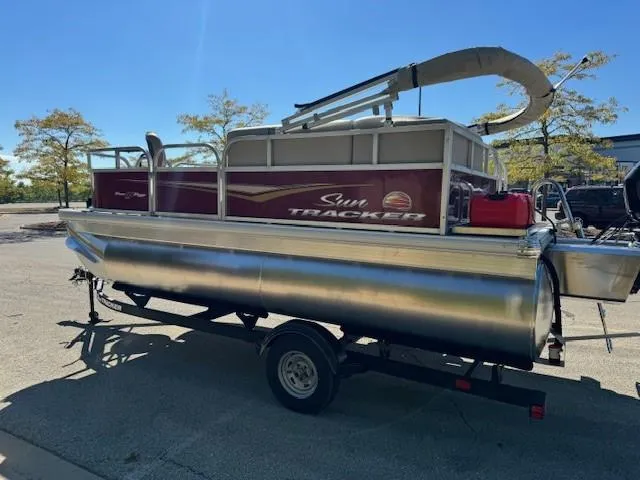 Slide: The Image of 2025 Sun Tracker Bass Buggy 16 XL Select pontoon boat on trailer. - 4