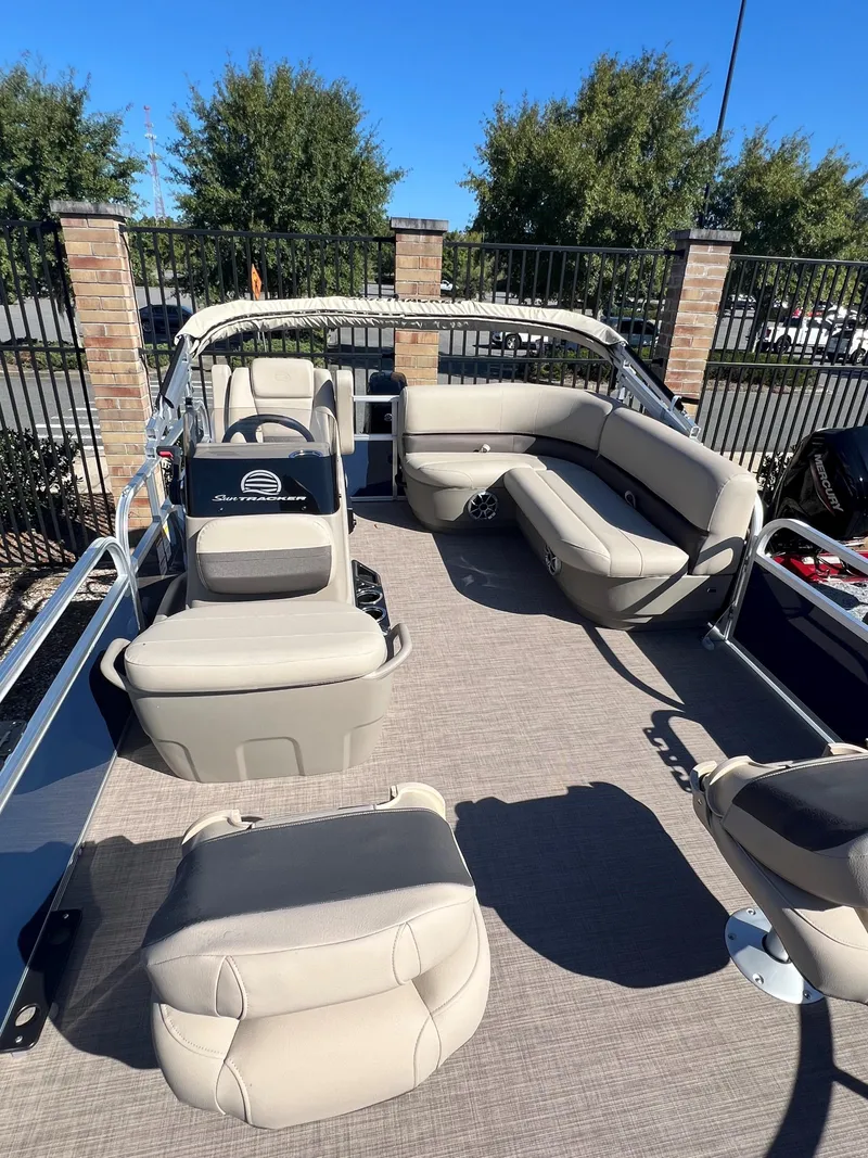 Slide: The Image of 2025 Sun Tracker Bass Buggy 16 XL Select pontoon boat with spacious seating and modern design. - 2