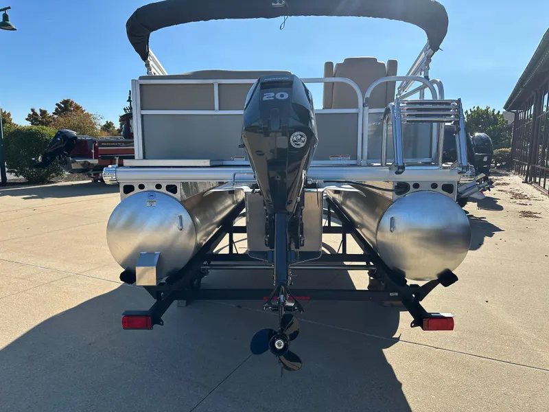 Slide: The Image of 2025 Sun Tracker Party Barge 16 DLX pontoon boat, rear view with motor. - 5