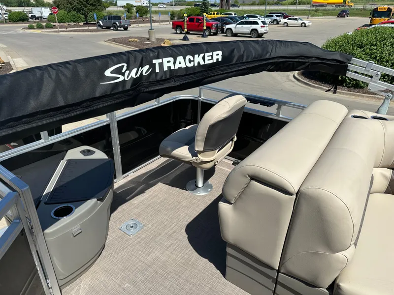 Slide: The Image of 2025 Sun Tracker SportFish 20 DLX pontoon boat interior with seating and helm. - 6