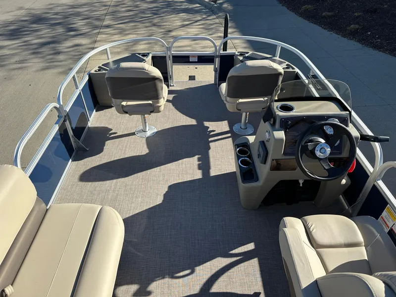 Slide: The Image of 2025 Sun Tracker Bass Buggy 18 DLX pontoon boat interior with seating and steering console. - 3