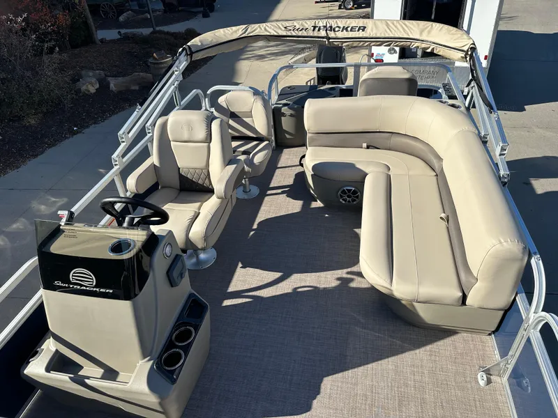 Slide: The Image of 2025 Sun Tracker Bass Buggy 18 DLX pontoon boat with beige seating and helm. - 4
