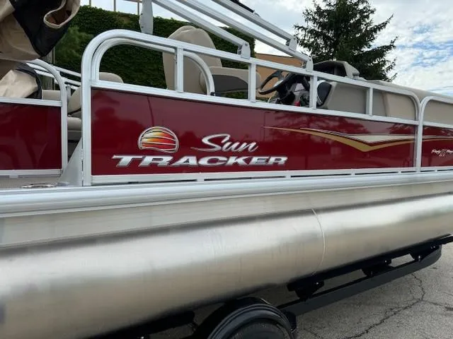 Slide: The Image of 2025 Sun Tracker Party Barge 18 DLX pontoon boat with red and white design. - 5