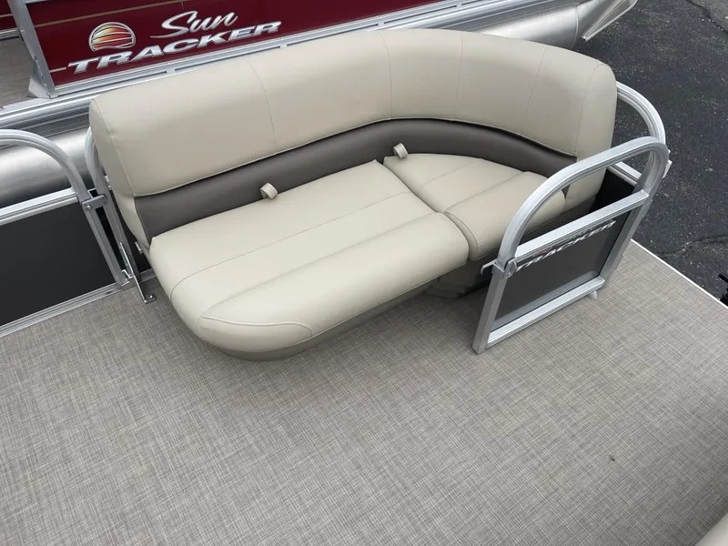Slide: The Image of Sun Tracker Party Barge 16 DLX 2025 with beige seating and railing. - 9