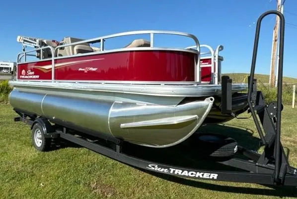 Slide: The Image of 2025 Sun Tracker Bass Buggy 16 XL Select pontoon boat on trailer, red and silver design. - 4