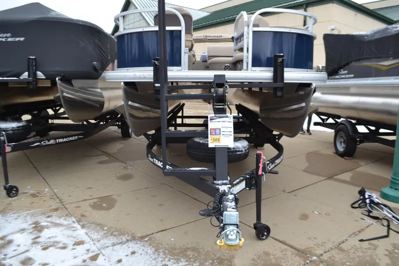 Slide: The Image of 2025 Sun Tracker Bass Buggy 16 XL Select pontoon boat on trailer. - 2