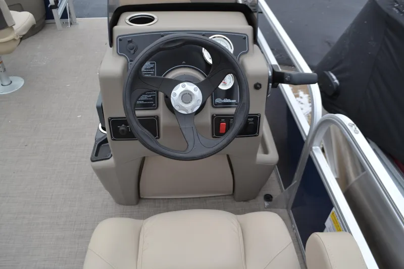 Slide: The Image of 2025 Sun Tracker Bass Buggy 16 XL Select steering console with beige seating. - 3