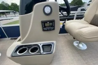 Slide: The Image of 2025 Sun Tracker Bass Buggy 18 DLX boat console with cup holders and control panel. - 15