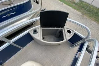 Slide: The Image of 2025 Sun Tracker Bass Buggy 18 DLX pontoon boat with open storage compartment. - 17