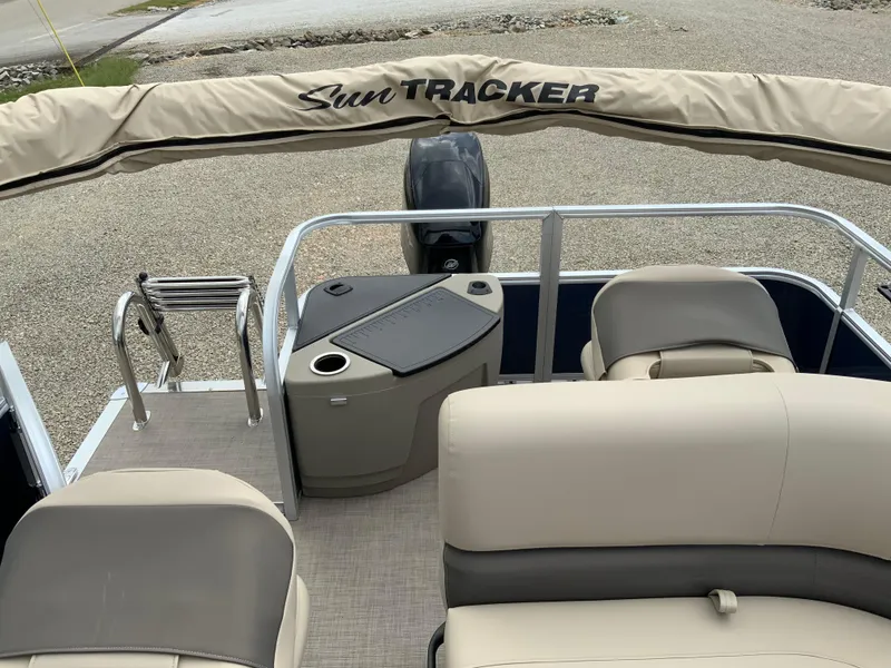 Slide: The Image of 2025 Sun Tracker Bass Buggy 18 DLX pontoon boat interior with seating and motor. - 8