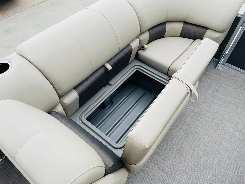 Slide: The Image of 2025 Sun Tracker Party Barge 20 DLX seating with storage compartment, beige upholstery. - 11