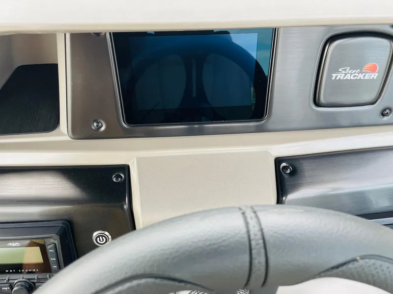 Slide: The Image of Dashboard of 2025 Sun Tracker Party Barge 20 DLX with steering wheel and control panel. - 22