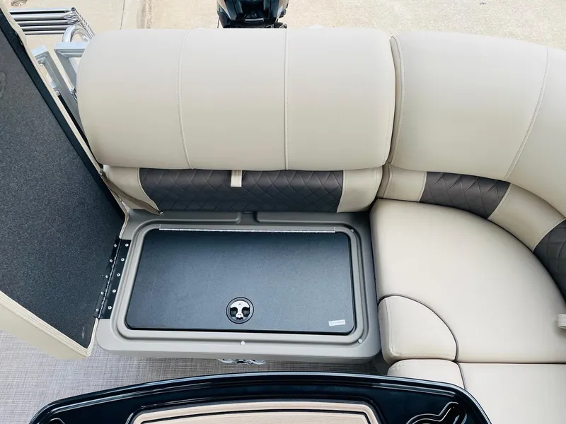 Slide: The Image of Sun Tracker Party Barge 20 DLX 2025 interior seating with storage compartment. - 29