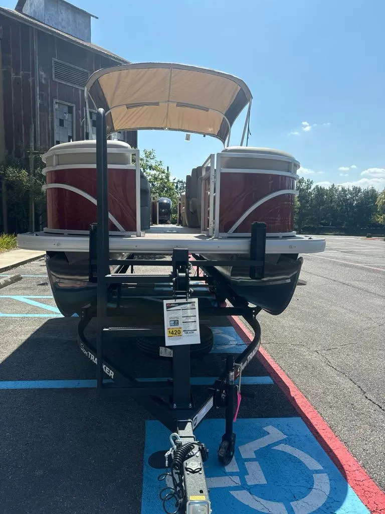 Slide: The Image of 2025 Sun Tracker Party Barge 22 DLX pontoon boat in parking lot. - 3