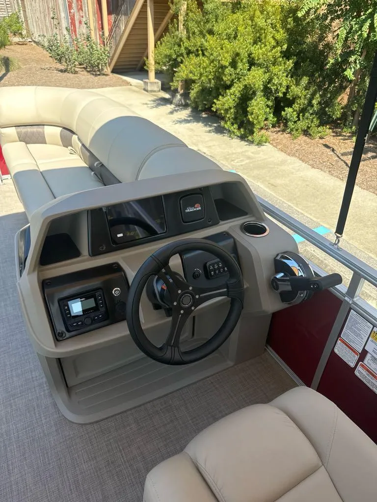 Slide: The Image of 2025 Sun Tracker Party Barge 22 DLX interior with steering console and seating. - 7