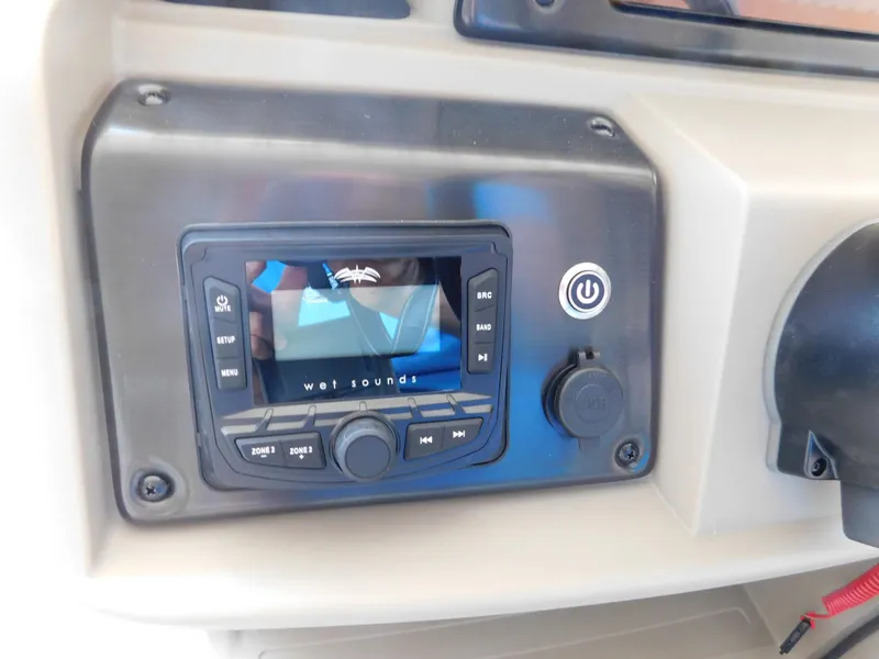 Slide: The Image of Control panel of 2025 Sun Tracker Fishin' Barge 22 DLX with Wet Sounds audio system. - 14